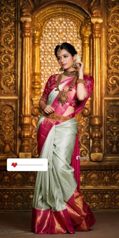 a woman in a pink and green sari