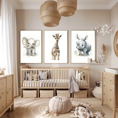 a baby's room with three pictures on the wall