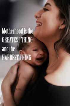 a woman holding a baby in her arms with the words motherhood is the greatest thing and the hardest thing