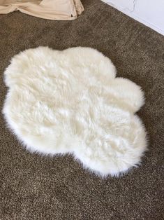 a white sheepskin rug is on the floor