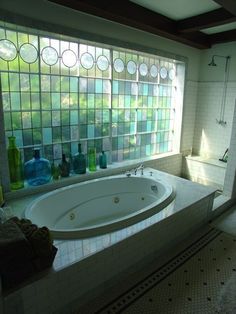 a bath tub sitting next to a window in a bathroom