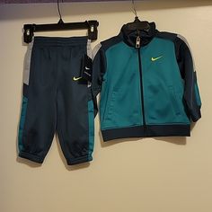 Nwt: Nike Boys 2 Piece Jacket And Pants Tracksuit Set Jacket: Front Full Zipper Closure Nike Swoosh On Left Chest 2 Front Functional Pockets Long Sleeves Pants: Elastic Waistband Nike Swoosh On Left Leg Elastic On Bottom Of Legs 100% Polyester Size: 12 Months Color: Squadron Blue Smoke Free And Pet Free Home Blue Hooded Sets For Spring, Blue Hooded Spring Sets, Winter Sports Sets With Pockets, Fitted Blue Tracksuit With Pockets, Blue Fitted Tracksuit With Pockets, Blue Sports Sets For Winter, Nike Long Sleeve Blue Set, Blue Sportswear Sets For Winter, Winter Sports Sets In Blue