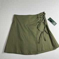 Wild Fable Skirt, Sie Xs, Olive Green In Color, Zipper And Hook And Eye In The Back, The String In The Front Is For Decorations Only, From The Waist Line To The Bottom Of The Skirt Is 15 Inches. Who What Wear Size Xl Color Lite Purple With Floral Print Long Sleeves With Elastic At Cuff Same Day Or Next Business Day Shipping, From A Nonsmoking Home, All Offers Are Welcome. Bundle With Other Items For A Discounted Price. Casual Flared Cargo Skirt For Summer, Casual Cotton Wrap Skirt In Relaxed Fit, Green Cotton Wrap Skirt For Spring, Casual Cotton Wrap Skirt With Lining, Casual Cotton Wrap Skirt, Casual Relaxed Mini Wrap Skirt, Casual Mini Wrap Skirt, Casual Mini Wrap Skirt With Lining, Green Flowy Lined Wrap Skirt