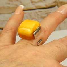 BUTTERSCOTCH AMBER 925 Silver RING, Heavy Bold Adjustable Ring, Alexander Gliwinski Ambermoda jewelry, Unique Gift For Her, Mothers Day Gift. From GEOMETRY COLLECTION by AMBERMODA. YELLOW STONE.  AMAZING RECTANGULAR BUTTERSCOTCH AMBER HAND POLISHED RAW STONE. EGG YOLK AMBER RING. UNISEX AMBER RING. STAMPED 925 and AG. COLLECTIBLE JEWELRY. Size of the stone 3/4in x 5/8in x 1/2in in height. ADJUSTABLE. CURRENT SIZE 7.5. RARE! UNIQUE AMBERMODA RING. MORE UNIQUE RINGS: https://www.etsy.com/shop/ANTI Yellow Polished Jewelry As A Gift, Yellow Jewelry With Polished Finish For Gifts, Unique Yellow Rings For Anniversary, Yellow Rectangular Ring As A Gift, Unique Yellow Ring Jewelry, Unique Yellow Jewelry Ring, Modern Yellow Rings For Anniversary, Adjustable Yellow Rings Suitable For Gifts, Adjustable Yellow Rings For Gift