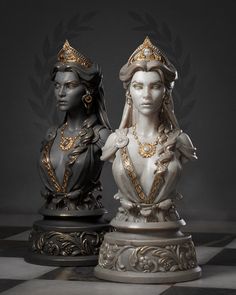 two statues sitting on top of a chess board