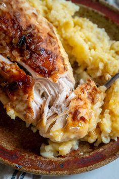 a close up of a plate of food with meat and mashed potatoes on it