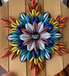 a wooden table topped with a colorful clock on top of it