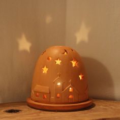 a wooden table topped with a brown and white light up dome on top of it