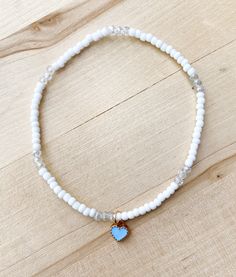 Something Blue Ankle Bracelet 💍 Looking for a touch of blue for your big day? This anklet is perfect. Perfect for the bride or the bridesmaids. 🤍💍 Simple, minimalist  Made with white 3mm seed beads and clear crystal precious stones. Blue and gold heart charm. Charm is about .25 inch and can be removed.  Other color options available by request*  CARING TIPS FOR YOUR JEWELRY ⭐️Treat and store with care. ⭐️ For longevity, avoid exposing your jewelry to water. ⭐️ Avoid having direct contact with Dainty White Wedding Anklets, Blue Anklet, Jewelry Bride, Bracelet Wedding, Bride Jewelry, Bridesmaid Bracelet, Ankle Bracelet, Bride Jewellery, Anklet Jewelry