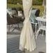 a white dress hanging on the side of a wooden pole in front of a patio