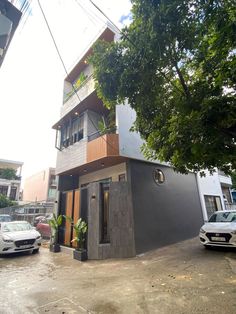 an apartment building with cars parked in front of it