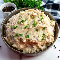 a bowl filled with mashed potatoes and garnished with parsley