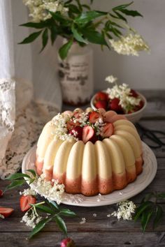 a bundt cake with strawberries and flowers on it