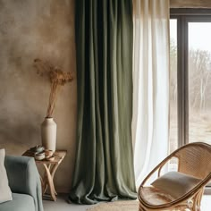 a living room filled with furniture and a window covered in green drapes next to a wooden table