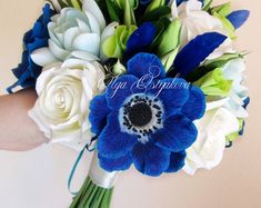 a bridal bouquet with blue and white flowers