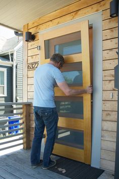 a man is opening the door to his house