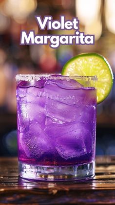 a purple drink with lime on the rim