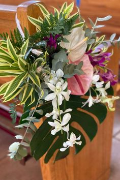 a bouquet of flowers sitting on top of a wooden chair