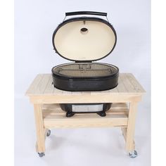 an old - fashioned cast iron skillet sits on top of a wooden table with wheels