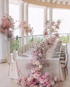 the table is set with flowers and chairs