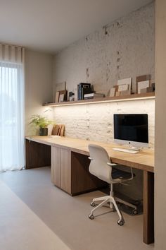 a desk with a computer on top of it in front of a wall mounted bookcase