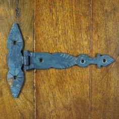 an old door handle on a wooden door that has been stained blue and rusted