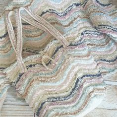 a multicolored bag sitting on top of a wooden floor