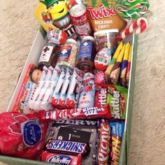 a green box filled with candy and snacks