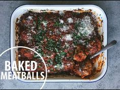 baked meatballs in a casserole dish with parmesan cheese