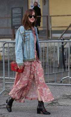 a woman in a pink dress and denim jacket