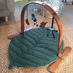 a baby crib with stuffed animals in it on the floor next to a couch