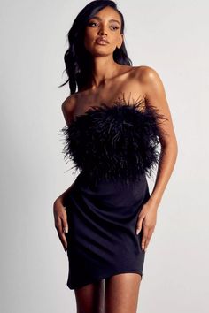 Our Annabelle Black Feather Dress is sure to wow the crowd at your next special event! It's made from black polyester and features an off-the-shoulder chic bodice and fitted skirt. Feathers adorn her neckline, adding a unique allure to the little dress. Simply complete the look with heels!Dress Length: Approx 72cmMaterials: PolyesterGentle Dry Clean OnlyThe model is 5 ft 74 and wears size SColor may vary due to lighting on images. The product images (without a model) are closest to the true colo Black Feather Dress, Feather Mini Dress, Mini Tube Dress, Asymmetrical Hem Dress, Tube Top Dress, Feather Dress, Tube Dress, Cutout Dress, Dress Cuts