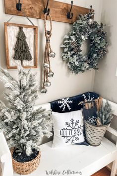 a white bench with christmas decorations and wreaths hanging on the wall above it, along with other holiday decor