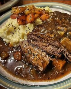 a plate topped with meat, potatoes and gravy