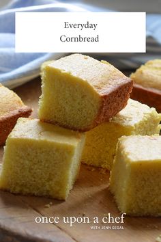 several pieces of cake sitting on top of a wooden cutting board