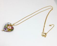 "What a lovely way to show your love to someone by giving them a gorgeous handmade glass heart. This Venetian Murano glass heart is sourced straight from the artisans of Venice, Italy. The techniques used to make these glass beads are hundreds of years in the making. The gold bead has genuine 14k gold foil within the glass. It is then hand painted with a unique color and design on each side of the heart. I have taken this bead and added 2 small gold plated beads to accent the heart and then it h Glass Heart Pendant Necklace For Gift, Multicolor Heart Necklace For Gift, Elegant Multicolor Heart Necklace For Valentine's Day, Elegant Multicolor Heart Pendant Necklace, Elegant Multicolor Heart Necklace For Gift, Elegant Multicolor Heart Necklace Gift, Valentines Day Jewelry, Heart Pendant Necklace Gold, Murano Glass Earrings