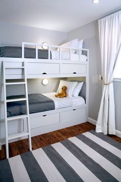 a bunk bed with two sets of drawers underneath it and a stuffed animal on the bottom shelf