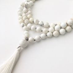 White Turquoise Mala This mala is made of 108 8mm faceted White Turquoise beads and measures 40 inches in length. It is best used for meditation, praying, or to obtain peace. For more necklaces, click here: http://etsy.me/1WMWiZL Shop's Homepage: GenuineBeadShop.etsy.com Before purchasing, make sure you read through our shop's policy. If you have any questions or want a custom order (different size, color), feel free to contact us on the Etsy convo or our email at thegenuinebeadshop [!at] gmail. Howlite Gemstone Beads Necklace, Elegant White Beaded Necklace For Meditation, White Adjustable Mala With Gemstone Beads, Adjustable White Mala With Gemstone Beads, Adjustable White Gemstone Beads Mala, Beaded Howlite Necklaces With Round Beads, Adjustable Howlite Beaded Necklace, Elegant Mala With 108 Beads For Meditation, Elegant Hand-strung Mala For Meditation