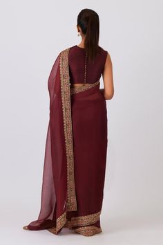 Mulberry marron saree with floral aari and zardozi borders flecked in gold and swarovski crystals. Comes with unstitched blouse piece.
Components: 2
Type Of Work: Floral
Fabric: Silk Organza
Color: Maroon
Other Details: 
Border detailing
Note: The stitched blouse worn by the model is not for sale
Occasion: Puja - Aza Fashions Formal Festive Dola Silk Saree, Anarkali Style Chanderi Pre-draped Saree For Formal Occasions, Formal Dola Silk Saree With Dupatta, Formal Anarkali Chanderi Pre-draped Saree, Formal Pre-draped Resham Embroidery Saree For Navratri, Formal Unstitched Dola Silk Saree, Chanderi Pre-draped Saree With Zari Work For Formal Events, Brown Saree With Pallu For Navratri, Formal Dola Silk Saree With Pallu