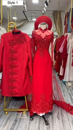 a red dress and coat on display in a store