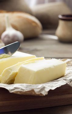 a piece of butter on a plate with a knife