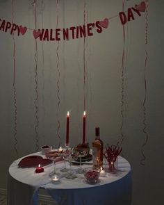 a table topped with candles and cake next to a sign that says happy valentine's day