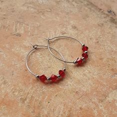 Add a touch of sparkle and elegance to your look with these stainless steel hoop earrings with Swarovski beads.  Perfect for any occasion and will add a touch of glamour to your style.  📝 Details:  30mm stainless steel hoop earrings and bicone Swarovski glass beads in clear or red color. 🔺 To keep them in perfect condition for a longer period of time, it is recommended NOT TO WET or expose to chemical products such as perfumes or detergents. 📧  All packages will be sent as CERTIFIED MAIL WITH Small Red Hoop Earrings For Everyday Wear, Small Red Hoop Earrings Nickel Free, Red Small Hoop Earrings For Everyday, Hypoallergenic Red Hoop Earrings For Everyday, Nickel Free Red Hoop Earrings, Sterling Silver Hoop Crystal Earrings For Gift, Small Red Hypoallergenic Hoop Earrings, Red Small Hoop Metal Jewelry, Small Hoop Red Metal Jewelry