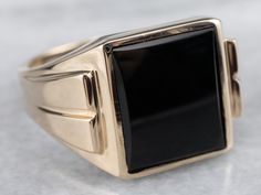 This vintage men's ring is stylish black onyx and yellow gold, a combination that is sophisticated and traditional. The design of this ring offers a little more size and substance but is still easy to wear. It sits flush to the hand and will be a great style piece for any man!Metal: 10K Yellow GoldGem: Black OnyxGem Measurements: 14.0 x 11.7 mm, RectangleRing Size: 12.50Marks: "10K B&F" Stamped on the inside band Men's Ring, Samsung Gear Fit, Classic Vintage, Statement Ring, Black Onyx, Vintage Men, Vintage Black, Statement Rings, Onyx