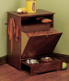 an open chest with food inside on the floor next to a green wall and wooden floors