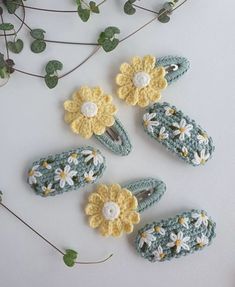 four crocheted slippers with flowers on them