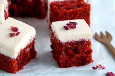 several pieces of red velvet cake with white frosting