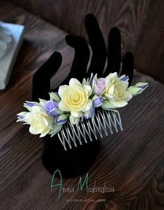 a hair comb with flowers on it sitting on a table