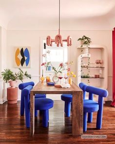 a dining room with blue chairs and a wooden table