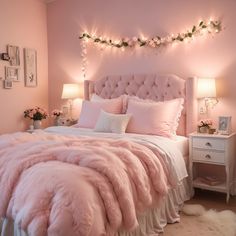 a bed with pink comforter and pillows in a room decorated for christmas or new year's eve